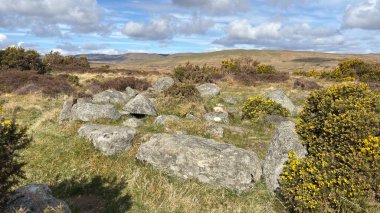 Countryside landscape near Milquhanzie Hill in Perth and Kinross Scotland showing ridge summit with masts, walking paths, and nearby ancient standing stones.