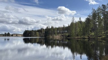 Countryside landscape near Milquhanzie Hill in Perth and Kinross Scotland showing ridge summit with masts, walking paths, and nearby ancient standing stones.
