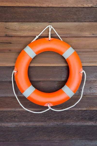 Orange lifebuoy on wooden wall — Stock Photo, Image