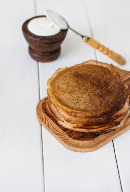 Delicious  pancakes  and cream on the table 