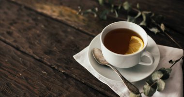 tea with lemon on wooden background 