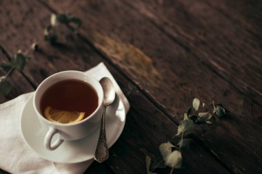 tea with lemon on wooden background 