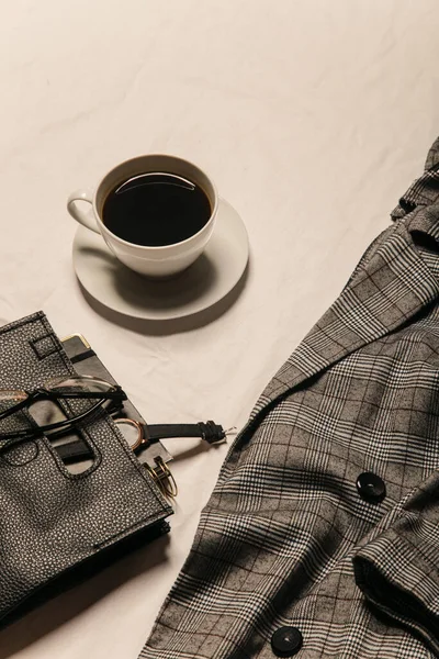 cup of coffee and flat lay fashion outfits