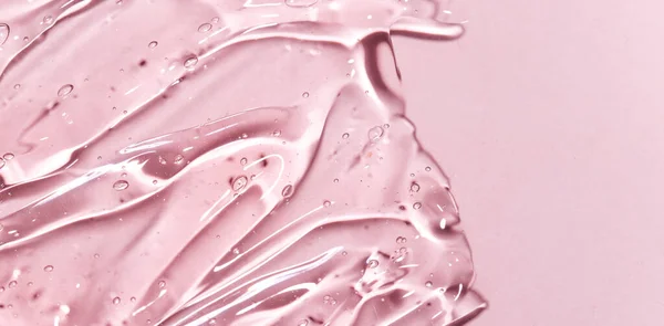 Pembe arka planda kozmetik jel dokusu