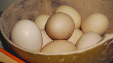 Kaptaki taze organik tavuk yumurtalarının yakın çekimi protein zengini bir kahvaltı için sağlıklı bir bileşeni temsil ediyor.