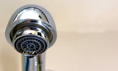 Düşen su damlası, su sızıntısı, atık, koruma, su tasarrufu, ev tesisat sorunu ve sürdürülebilirlik kavramının sembolü olan musluk vanasının yakın çekimi.