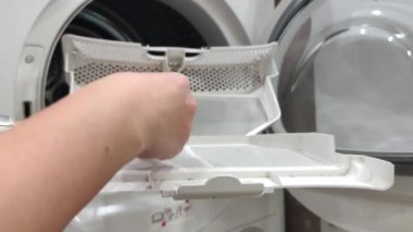 Kadın kurutma makinesinin filtresini temizliyor. Yüksek kalite 4k görüntü