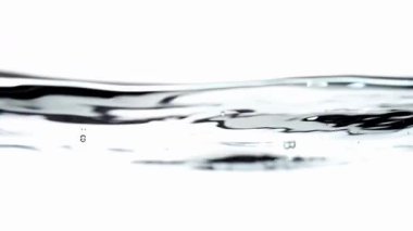 Clean slow motion water surface with ripples and fluid movement on a minimal background.