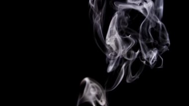 Yoğun ya da ince beyaz duman sinemanın efektleri için siyah arkaplan üzerinde yavaşça kıvrılıyor.