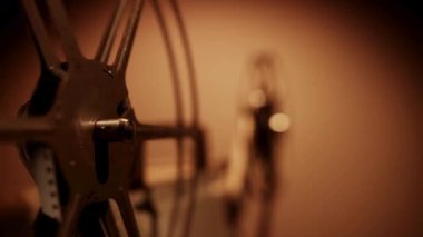 Nostaljik bir atmosfer havası yaratmak için projektörde dönen, sıcak sinematik ışıklandırma ve karanlık arka planda dönen klasik filmlerin ayrıntıları