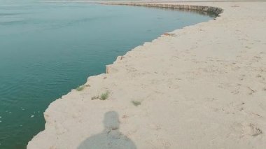 Nehir yatağındaki sığ su birikintilerine gölge yansıması