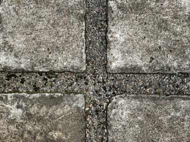 Close up of outdoor paving stone with black pebbledash and rough cast. Rough textured paving stone, suitable for exterior garden footpath. Seamless background texture.