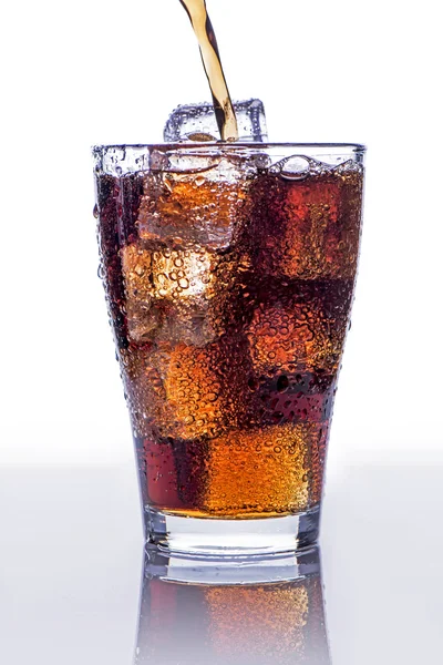 Pooring soft drink in a glass with ice — Stock Photo, Image