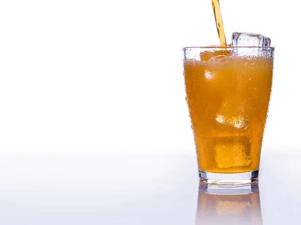 Pooring soft drink in a glass with ice — Stock Photo, Image