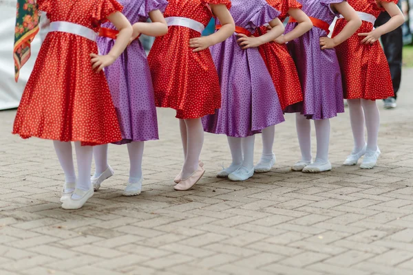 Legs girls in color dresses — Stock Photo, Image