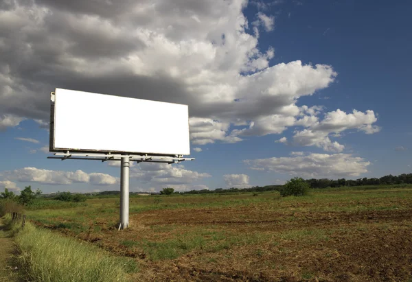 Empty billboard in front of beautiful cloudy sky in a rural location Royalty Free Stock Photos