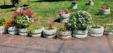 Geri dönüşümlü malzemelerden yapılmış renkli çiçek bahçesi. Basit yaşam tarzı ve vicdani yeşil görüntü konsepti.