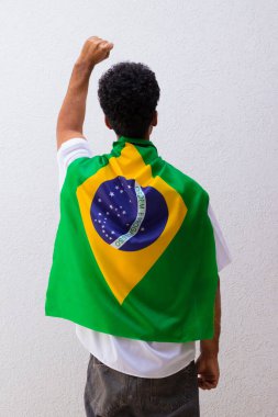 Brezilya bayraklı kahraman pelerinli bir adamın arkasında..