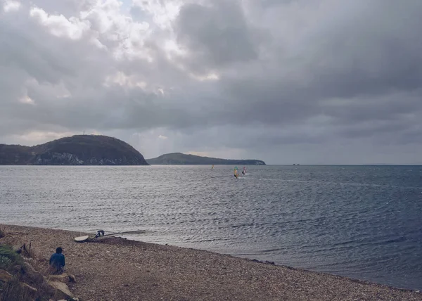 Vladivostok Russia October 2020 Man Sitting Beach Looking Windsurfers Stormy — Stock Photo, Image