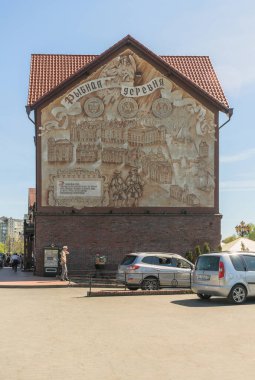 Kaliningrad, Rusya - 10 Mayıs 2021: Yürüyen insanlar ve park halindeki arabalarla modern köyün açılmasına adanmış duvar sanatı