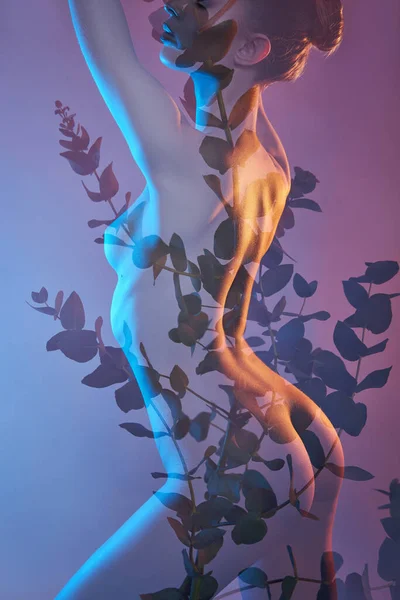 Beauty flowers body of woman with double exposure. Portrait of a girl neon light and color, professional makeup, nude back and chest of woman, flowers inside