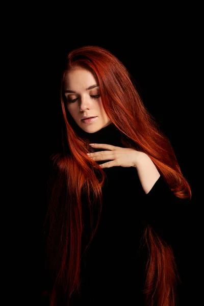 Redhead girl with long hair contrast art portrait. Perfect woman on black background. Gorgeous hair and beautiful eyes. Natural beauty, clean skin, facial care and hair. Strong and thick hair