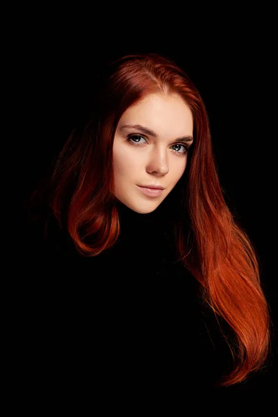 Redhead girl with long hair contrast art portrait. Perfect woman on black background. Gorgeous hair and beautiful eyes. Natural beauty, clean skin, facial care and hair. Strong and thick hair
