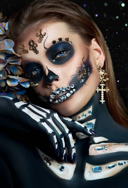 Halloween beauty skeleton woman makeup face Bokeh glitter. Girl death Halloween costume. Day of The Dead. Charming and dangerous Calavera Catrina