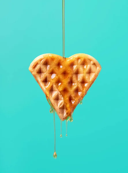Pouring Maple Syrup One Heart Shaped Waffle Green Colored Background — Stock Photo, Image