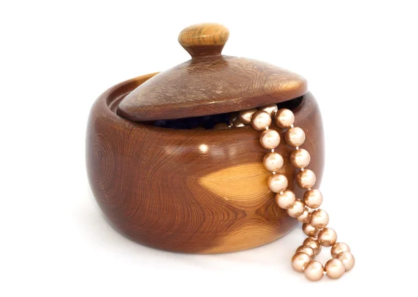 Wooden box with beads on white background