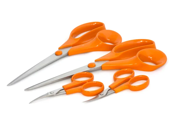 Four scissors with orange handles on white background — Stock Photo, Image