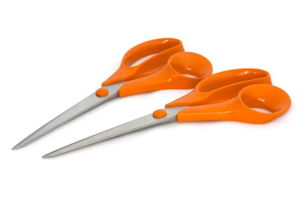 Two scissors with orange handles on white background — Stock Photo, Image