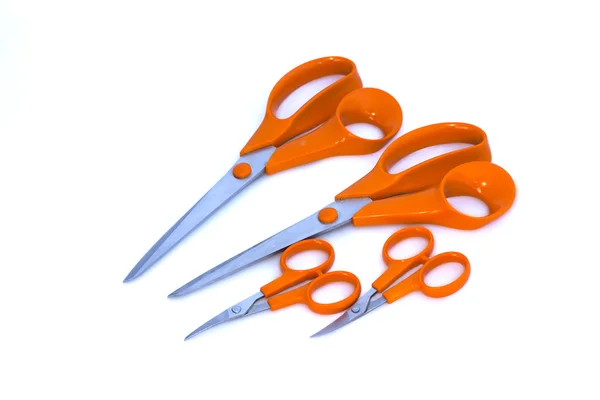 Four scissors with orange handles on white background — Stock Photo, Image