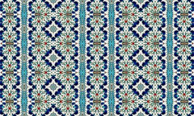 Beyaz zemin üzerinde mavi, kırmızı ve yeşil desenler içeren renkli ve karmaşık bir çiçek deseni, pürüzsüz ve tekrarlayan bir doku oluşturur..