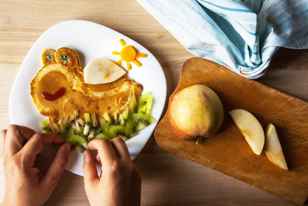 Mom prepares a funny children's breakfast — Stock Image Mom prepares a funny children's breakfast Stock Picture