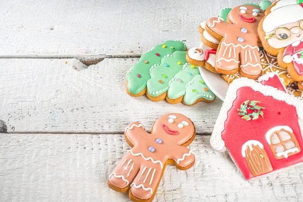 Christmas background with homemade gingerbread cookies. Traditional winter festive baking, Flat lay, om white wooden background copy space.