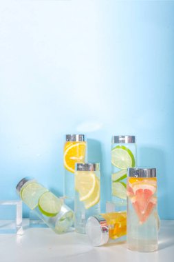 Şişe içinde çeşitli soğuk içecekler, yaz aşılamalı su şişeleri, limonata sağlıklı kokteyller limon, portakal, greyfurt, ıhlamur, parlak arka plan kopyalama alanı