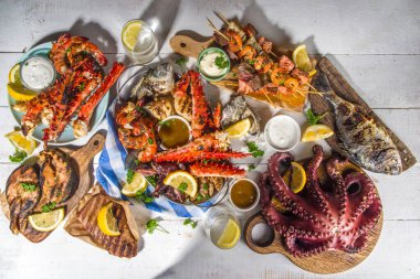 Çeşitli barbekü çeşitleri Akdeniz ızgara gıdaları - balık, ahtapot, karides, yengeç, deniz ürünleri, midye, yaz diyet bbq parti şenliği, kebap, sos, beyaz ahşap arka plan, fotokopi alanının üstünde