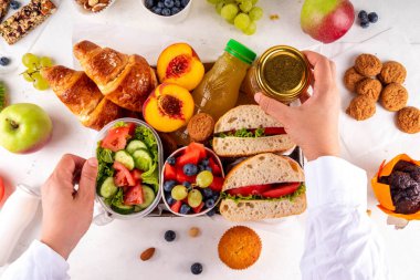 Hazırlık ya da hazır brunch kutusu sandviç, salata, kruvasan, tatlı olarak kurabiye ve meyve suyu, meyve suyu ya da meyve suyu. Kısa bir öğle yemeği molası, zaman tasarrufu, sağlıklı yemek. 