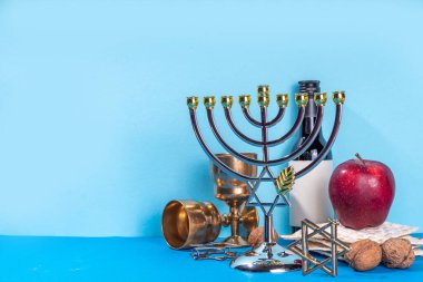 Passover, Pesah background. jewish Easter Passover spring holiday celebration, with accessories - menorah, matzo, spring flowers, wine bottle, gold wine glass, jewish david stars