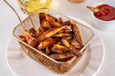 Patates cipsi sağlıklı alternatif, patates kızartması porsiyonlu sepette ketçap soslu patates kızartması.