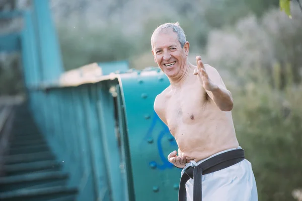 Older man practicing martial arts