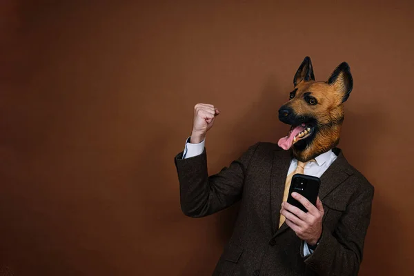 Ein Beschwingter Mann Mit Smartphone Und Latex Hundekopfmaske Hebt Die — Stockfoto