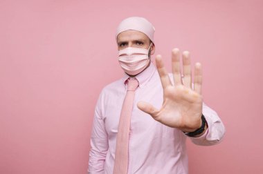 Fularlı ve pembe maskeli adam, kanserle dayanışma içinde.