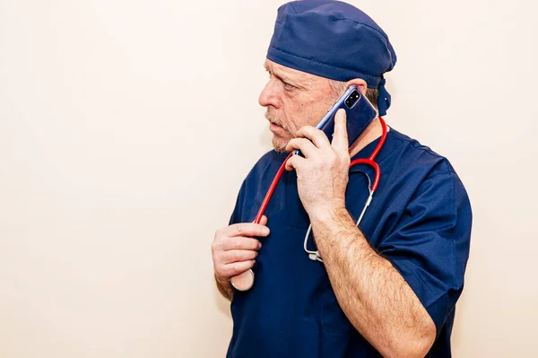 Veteran doctor talking to a smart phone