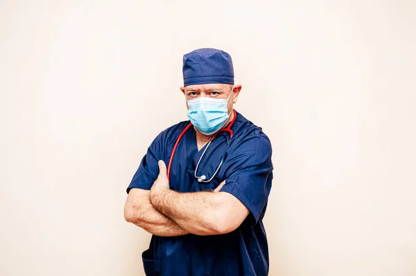 Studio portrait of a veteran doctor in an operating room suit