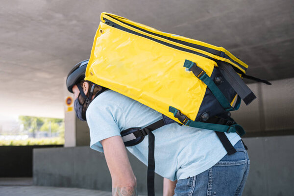 Food delivery service by delivery service. Cyclist with mask for safety.
