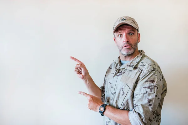 Hombre Sorprendido Uniforme Camuflado Del Ejército Señalando Con Dos Manos — Foto de Stock