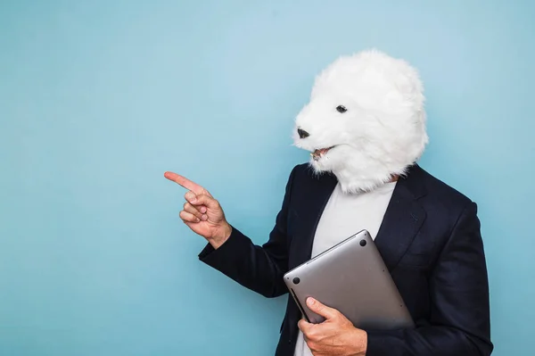 Man in a polar bear mask using a laptop.