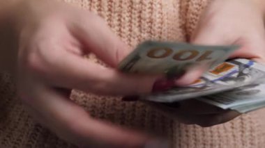 Yüz Amerikan doları sayan tanınmayan bir kadın.